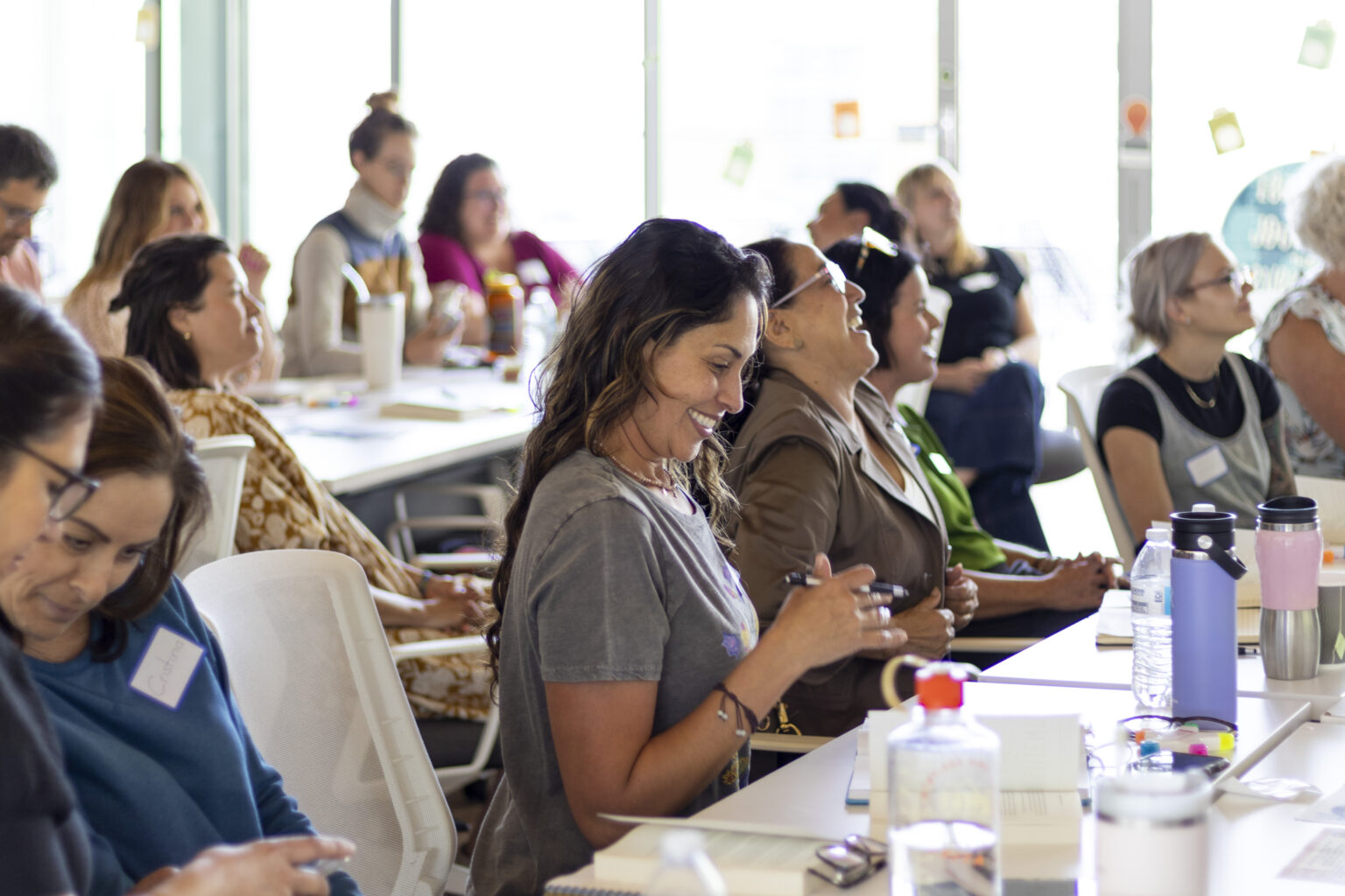 Workshop attendees smile and laugh during a presentation at a CRLP event.